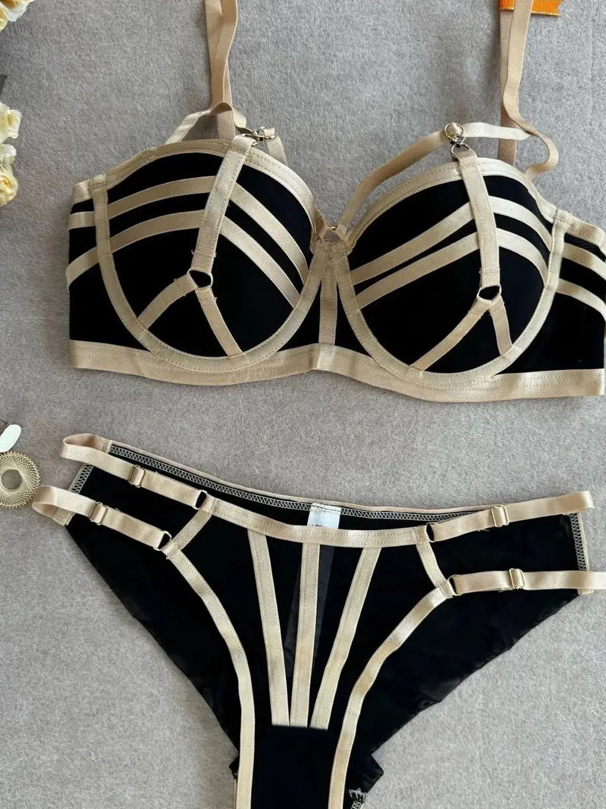 Black bra with gold trim close-up showing fine stitching detail