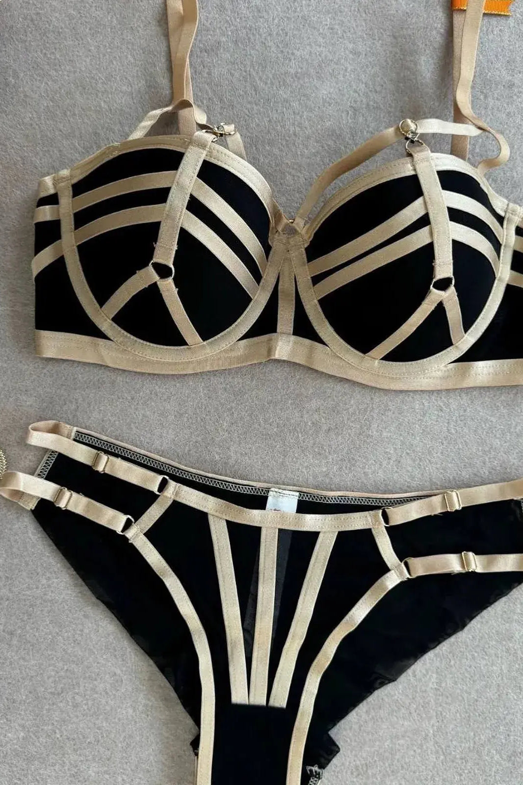 Black bra with gold trim close-up showing fine stitching detail