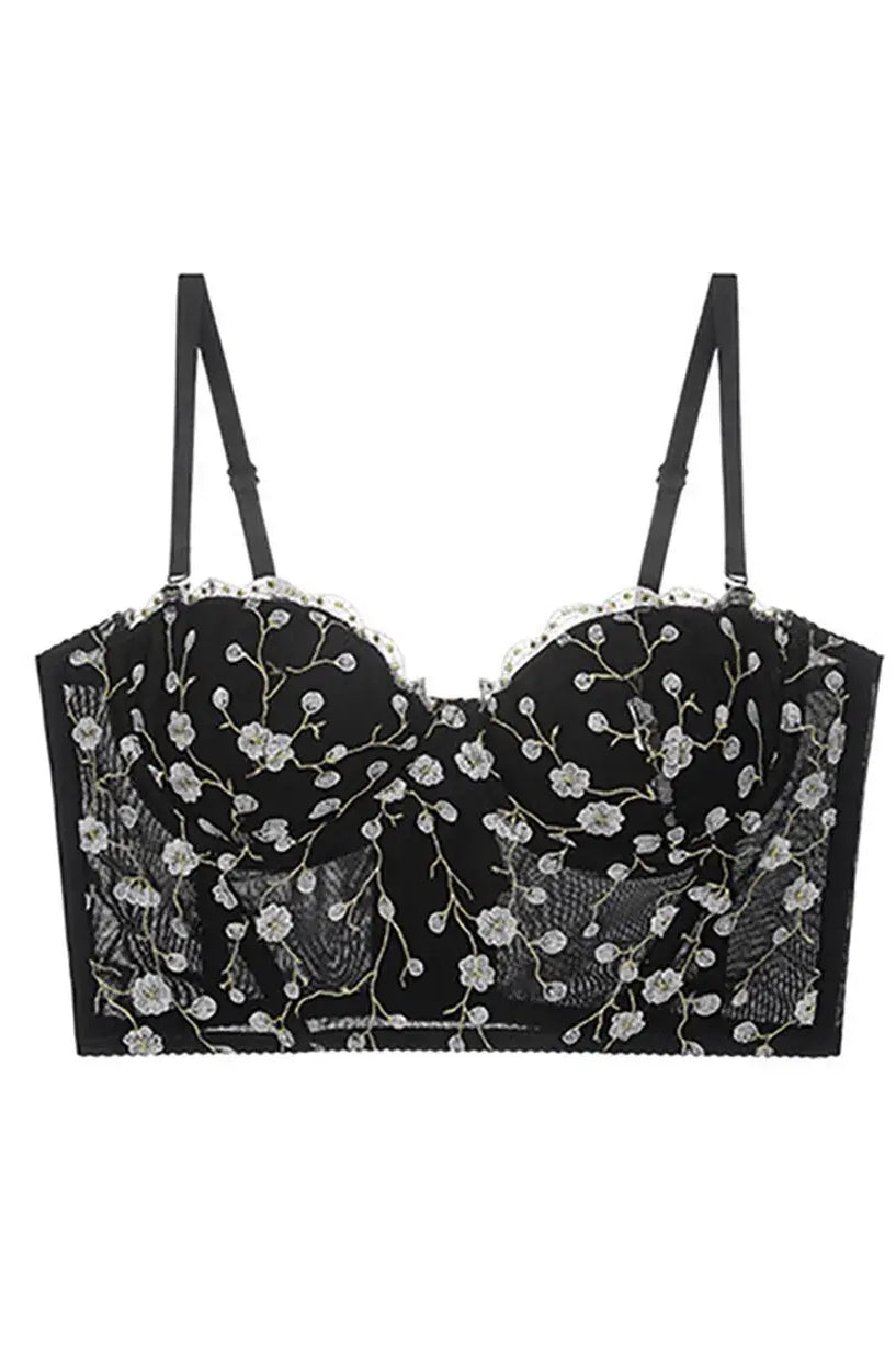 Display of black bustier top lingerie with golden embroidery and sheer lace accents, elegant and bold.