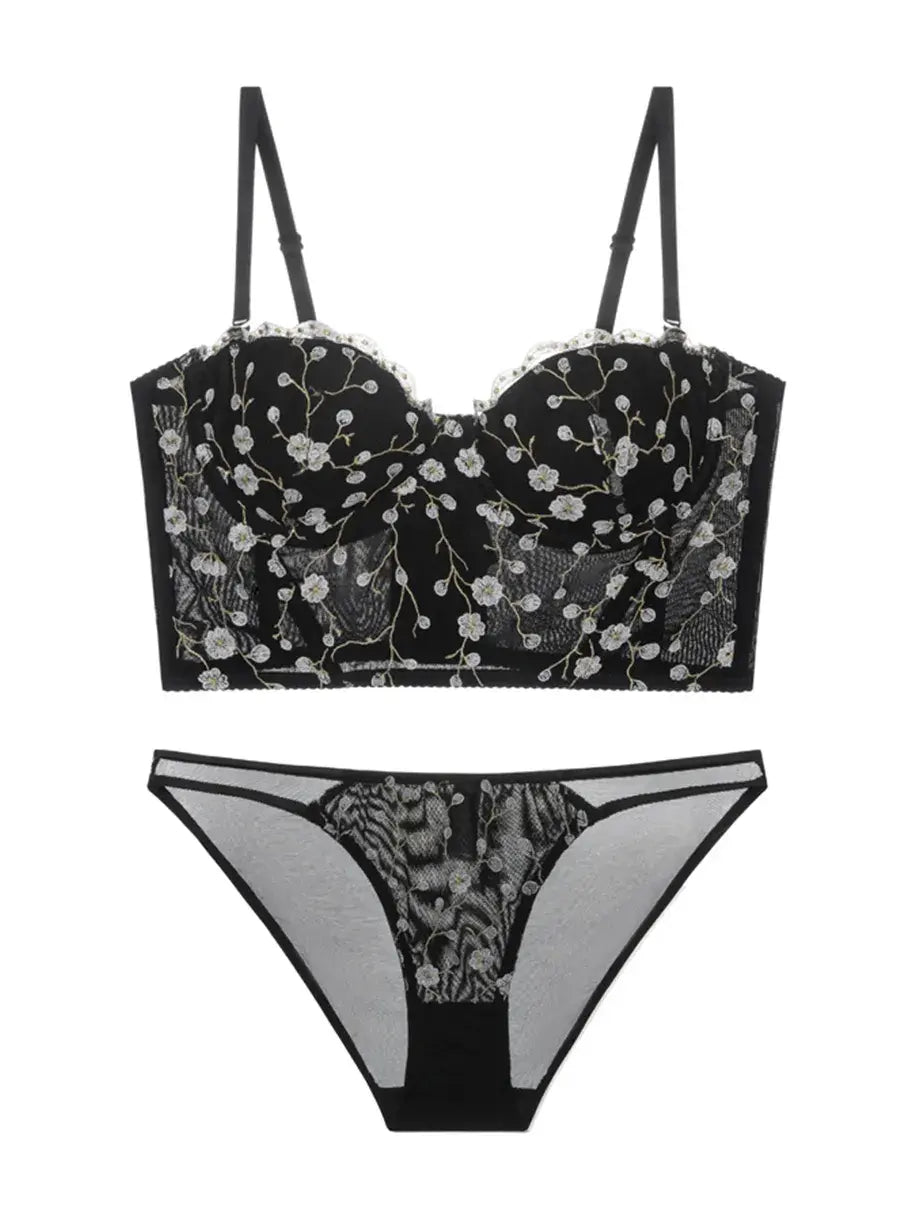 Flat lay back view of black and gold embroidered corset lingerie set, showcasing mesh structure and lace finish.