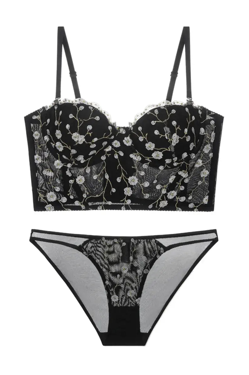 Flat lay back view of black and gold embroidered corset lingerie set, showcasing mesh structure and lace finish.