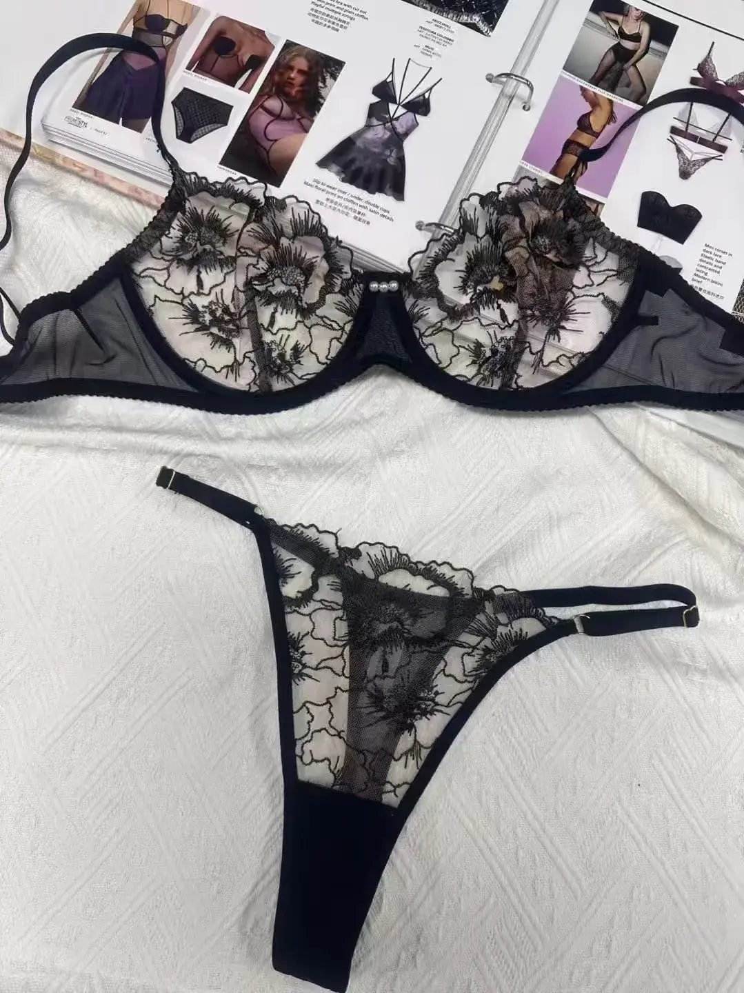 Back of black embroidered mesh lingerie set with elegant gold thread pattern adding high-end appeal.