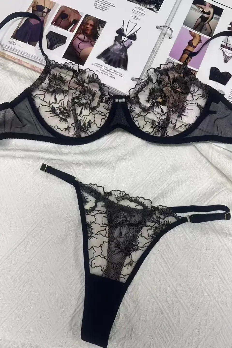 Back of black embroidered mesh lingerie set with elegant gold thread pattern adding high-end appeal.