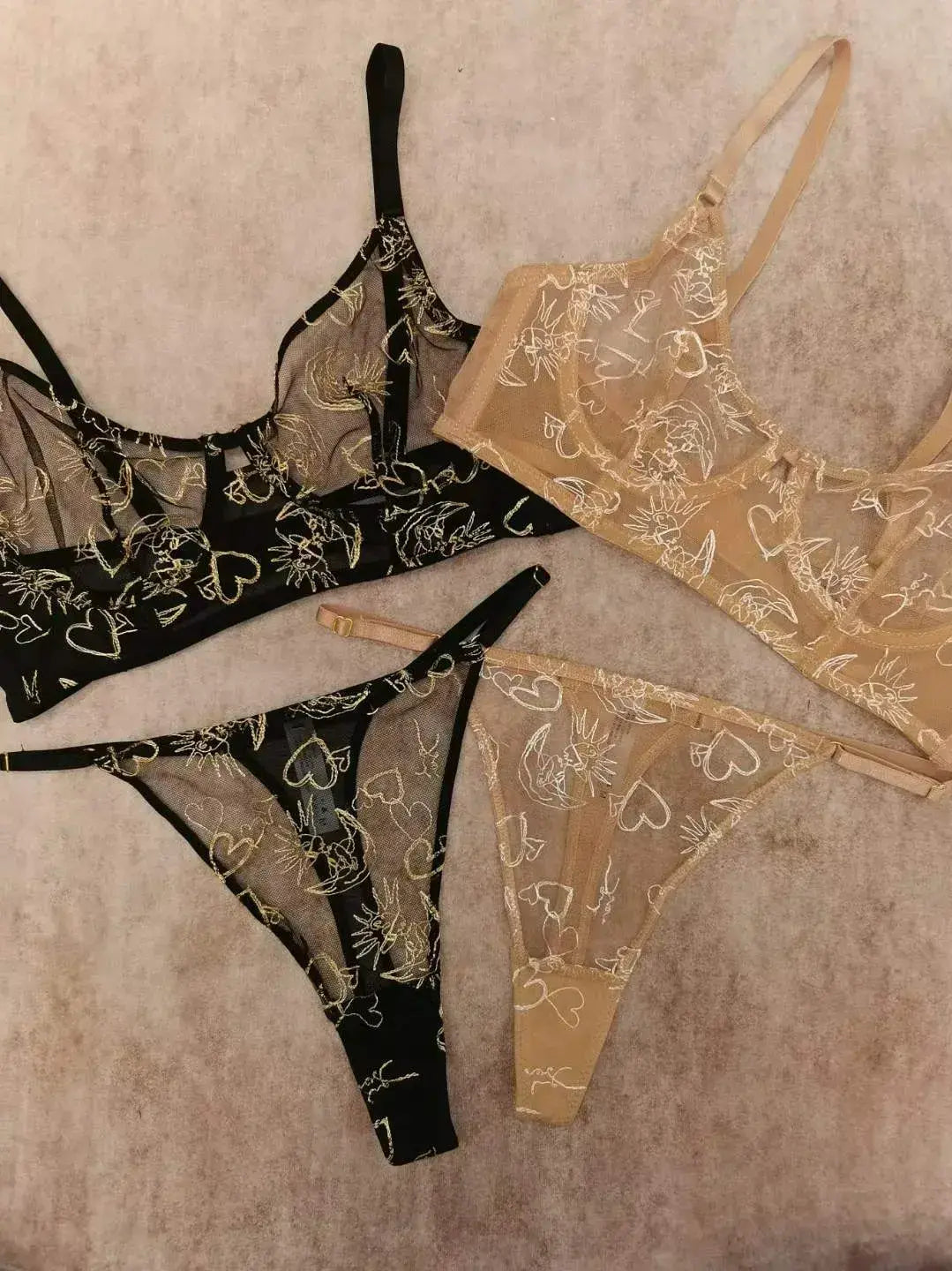 Comparison between Black Gold Sun & Moon Corset Set and Nude Gold Celestial lingerie highlighting color and embroidery contrast.