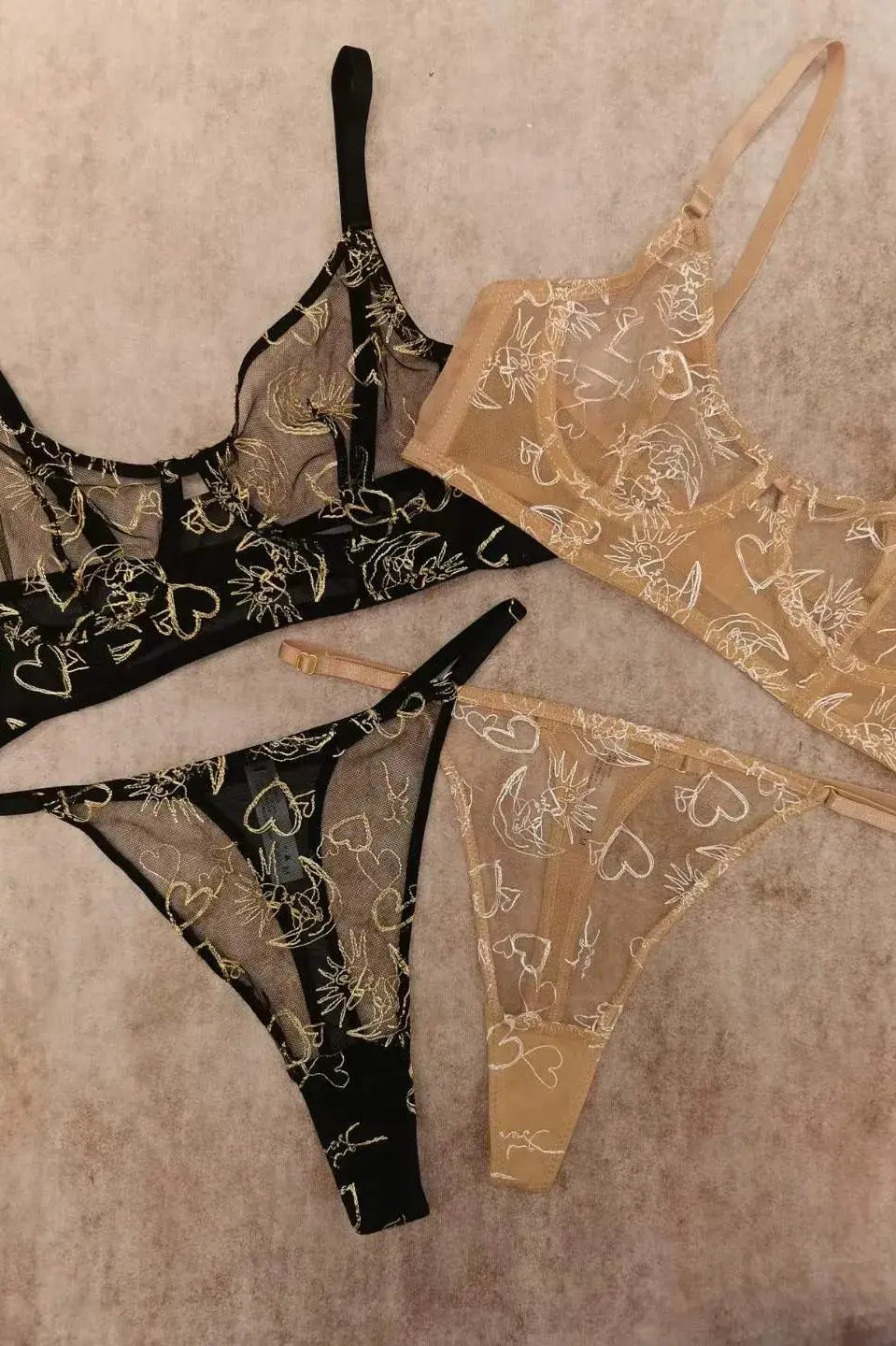 Comparison between Black Gold Sun & Moon Corset Set and Nude Gold Celestial lingerie highlighting color and embroidery contrast.