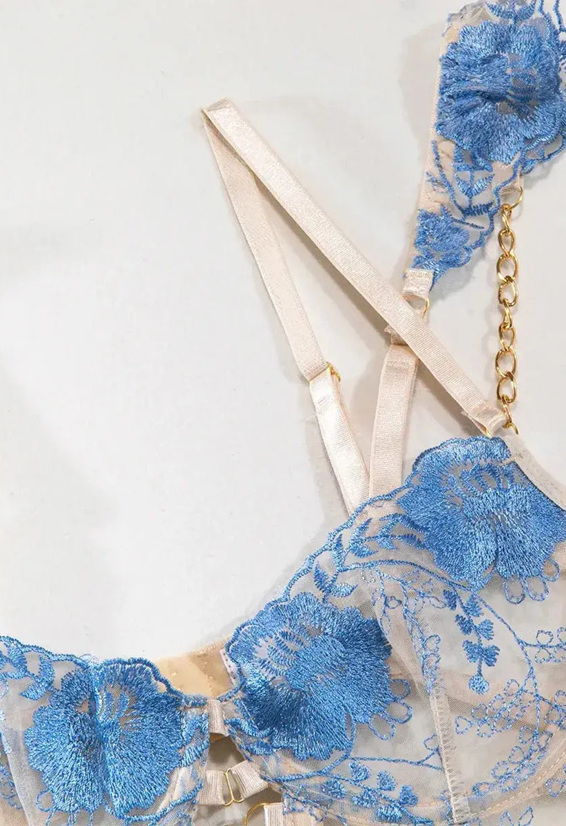 Blue lace bra with embroidered floral patterns and adjustable satin straps, feminine and delicate