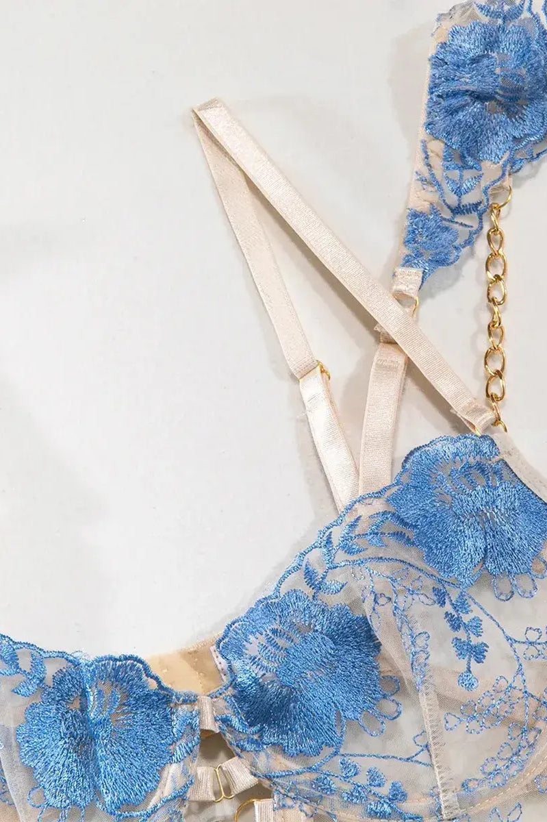 Blue lace bra with embroidered floral patterns and adjustable satin straps, feminine and delicate