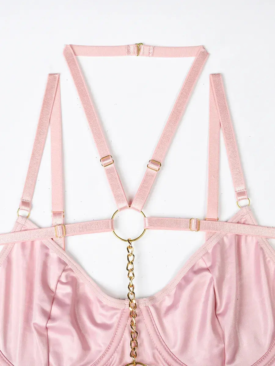 Layered pink elastic bands with luxe gold rings and metal accents, adding modern edge to the Blush Bond lingerie set.