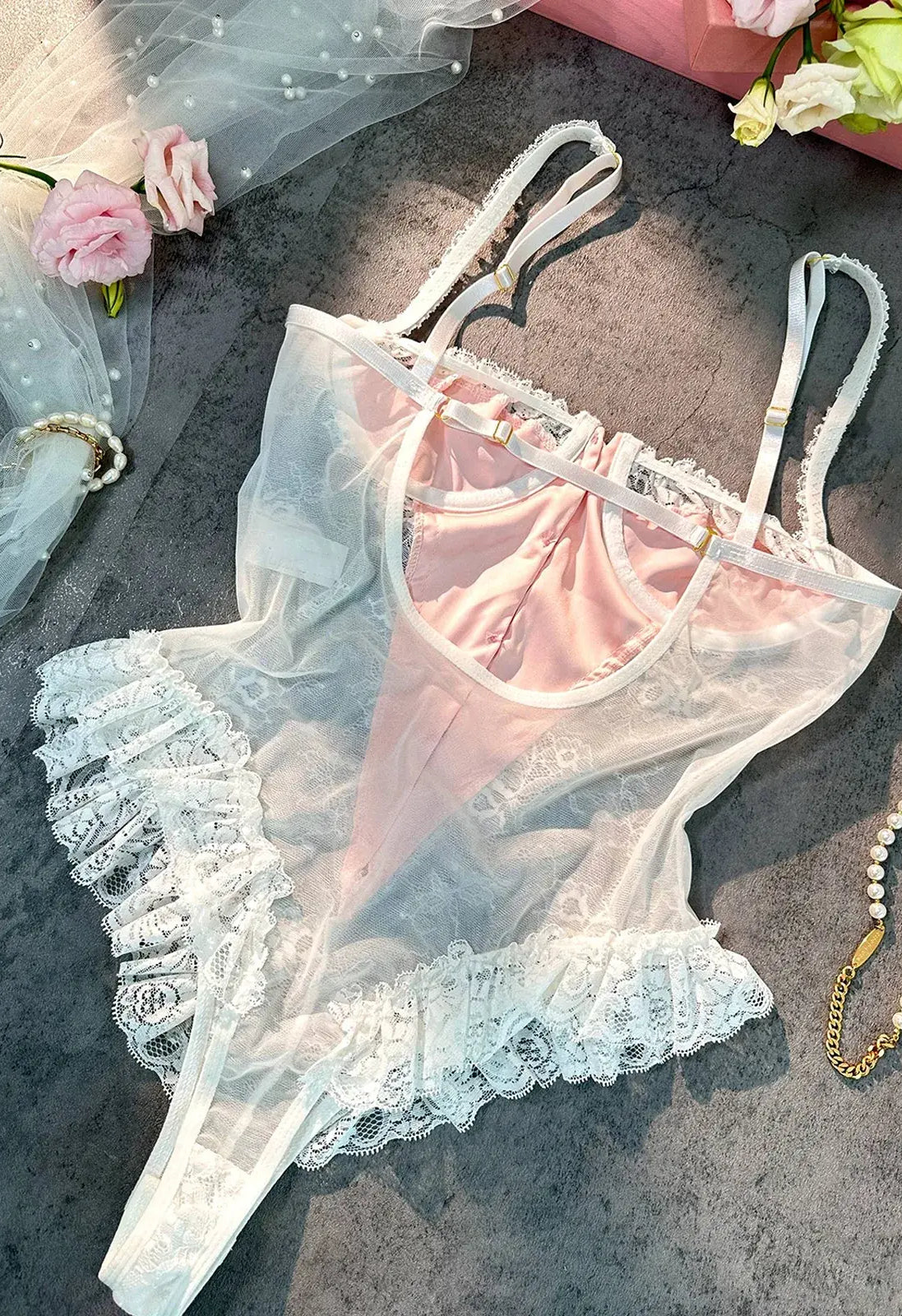 Layflat image showing fabric texture and satin sheen of Blush Pink Satin Lace Teddy.