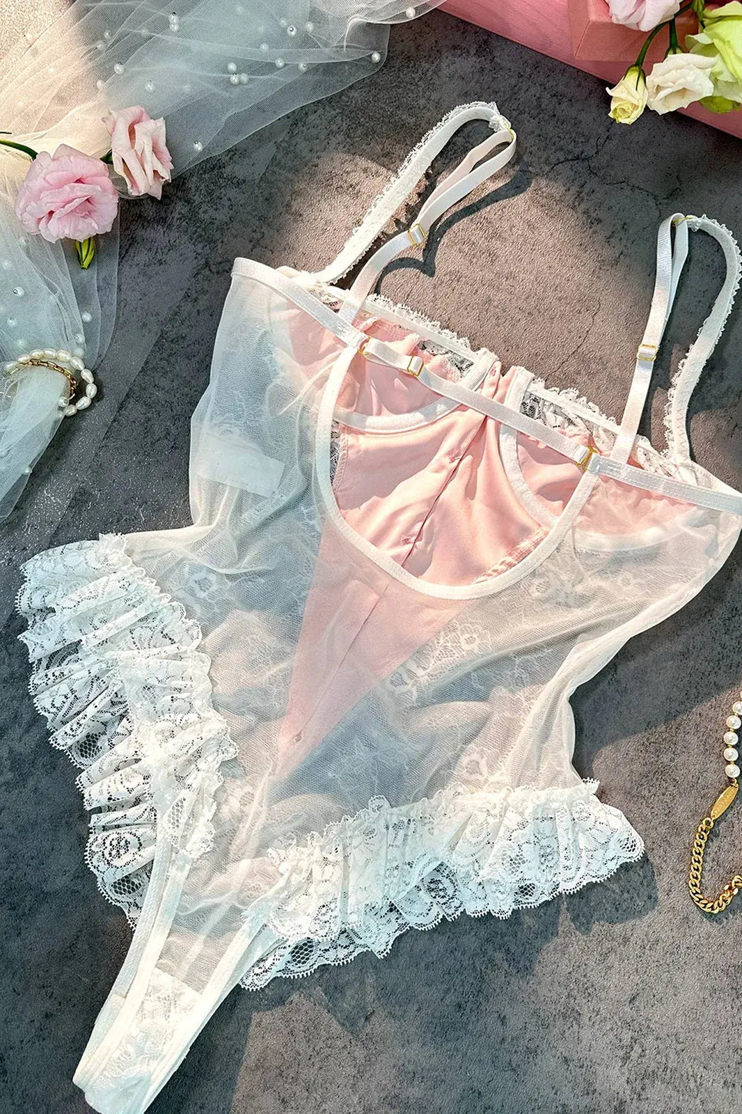 Layflat image showing fabric texture and satin sheen of Blush Pink Satin Lace Teddy.