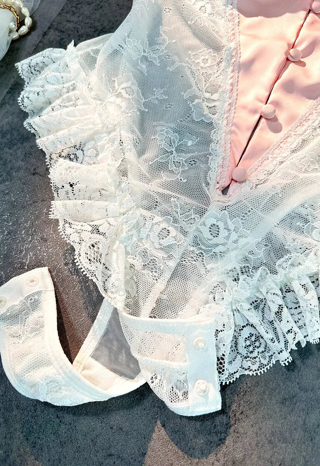 Close-up of open crotch design on Blush Pink Satin Lace Teddy showcasing functional detail.