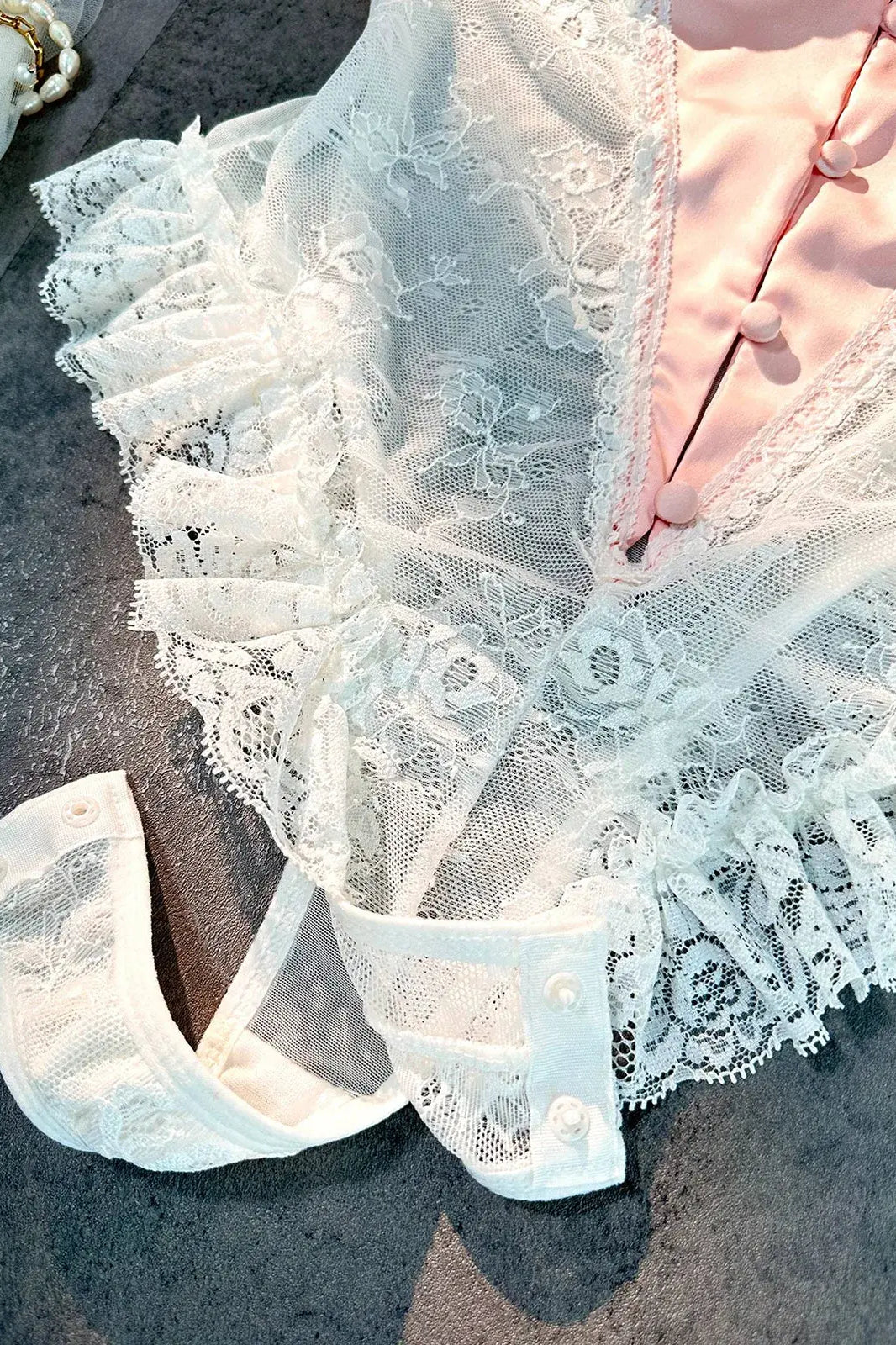 Close-up of open crotch design on Blush Pink Satin Lace Teddy showcasing functional detail.