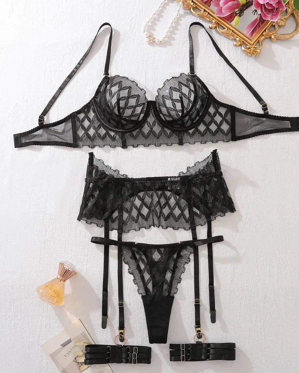 flat lay of geometric lace lingerie set with garter belt and thong