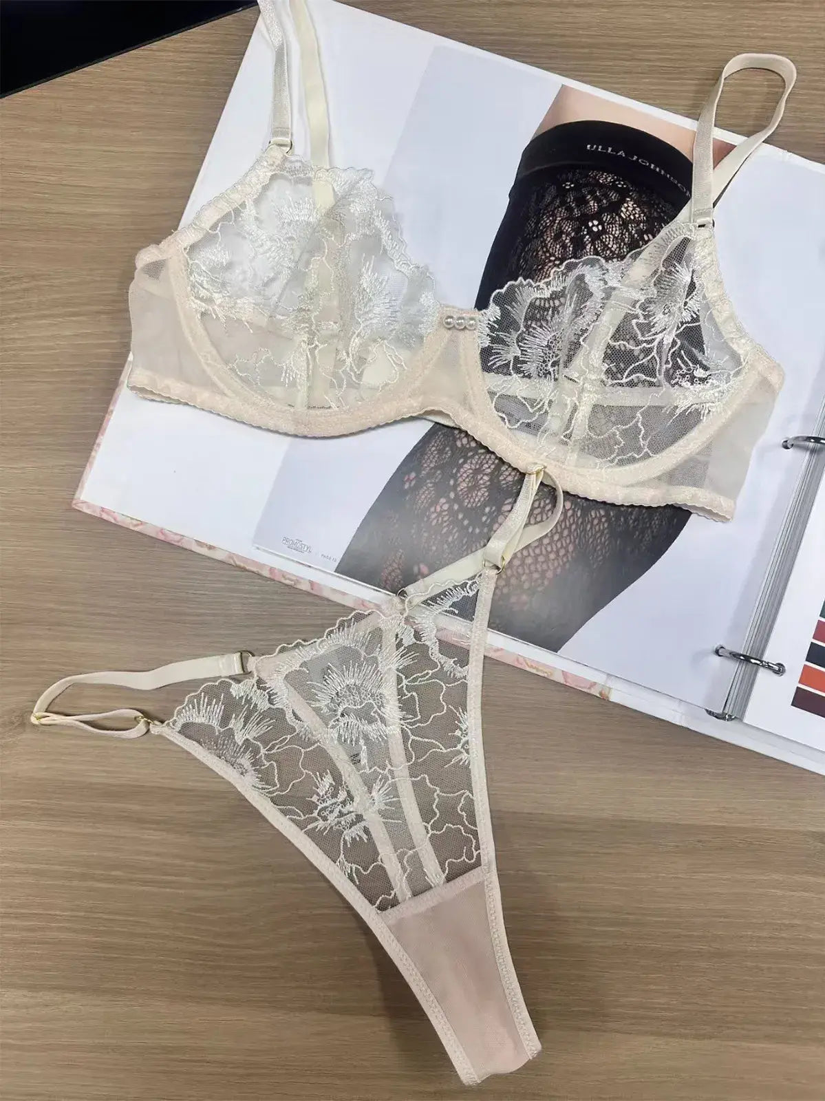 Flatlay view of Ivory Whisper embroidered lingerie showing lace and mesh balance in fabric distribution.