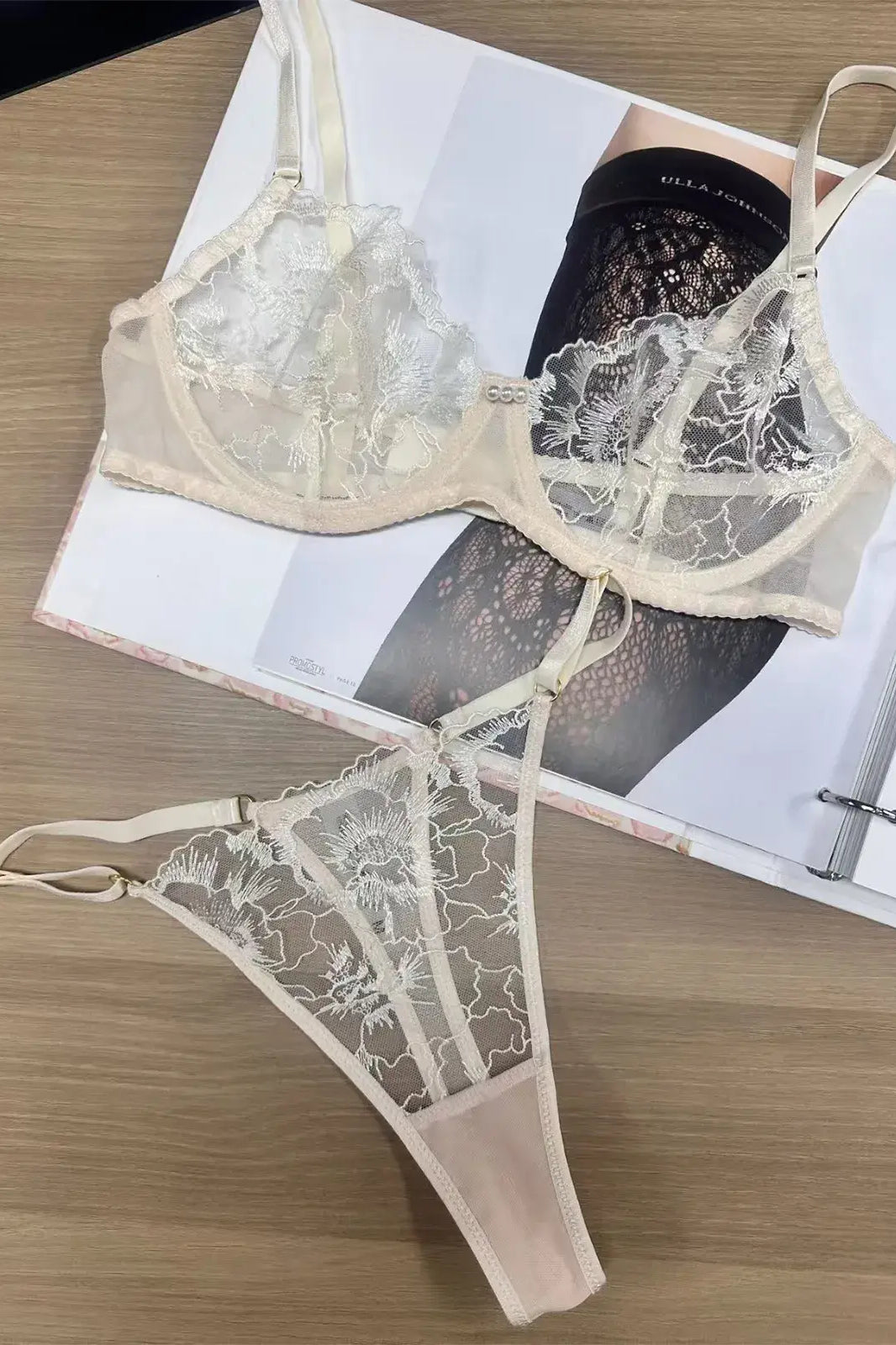 Flatlay view of Ivory Whisper embroidered lingerie showing lace and mesh balance in fabric distribution.