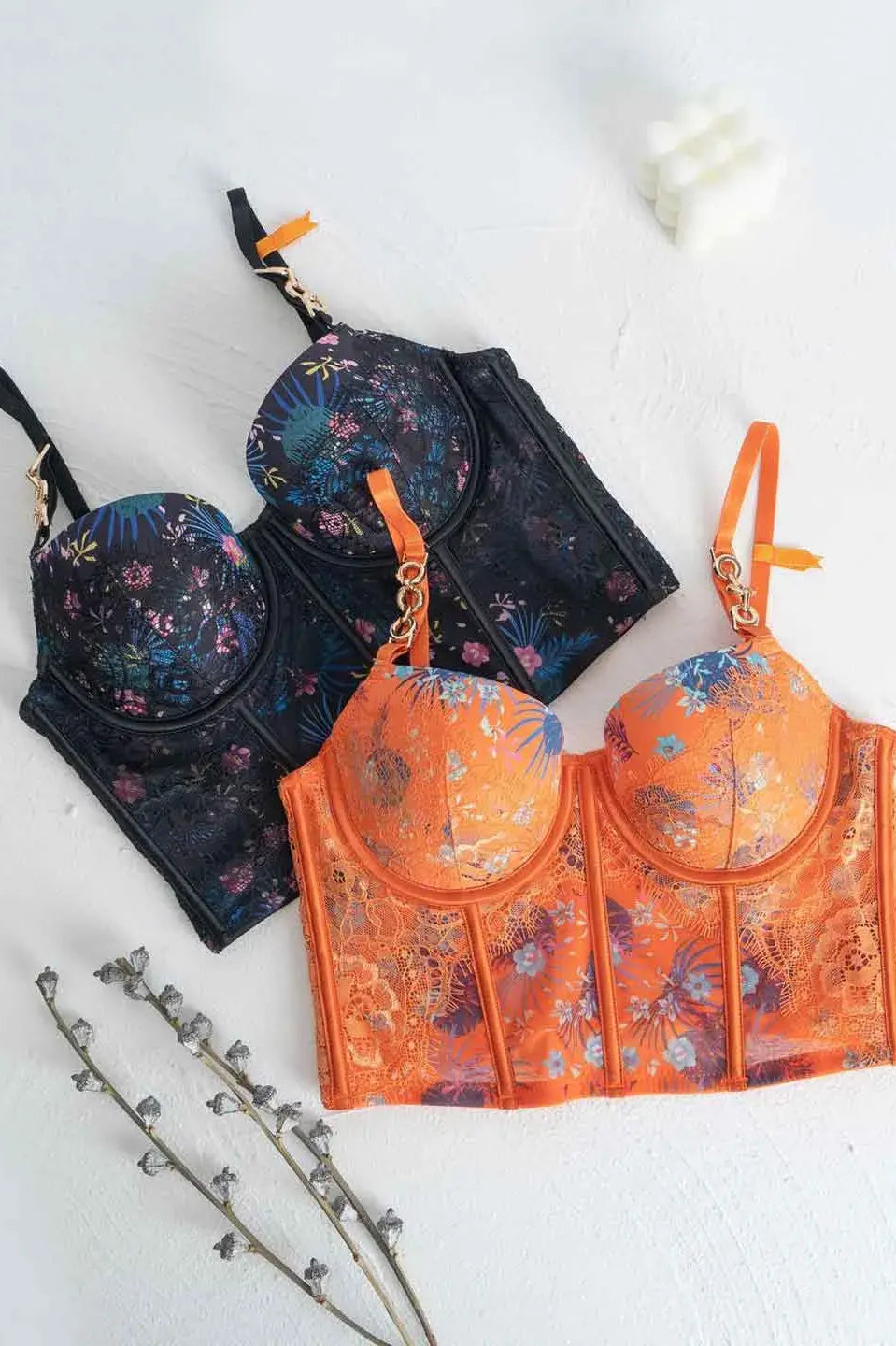Lace lingerie set flatlay in orange and black color options.