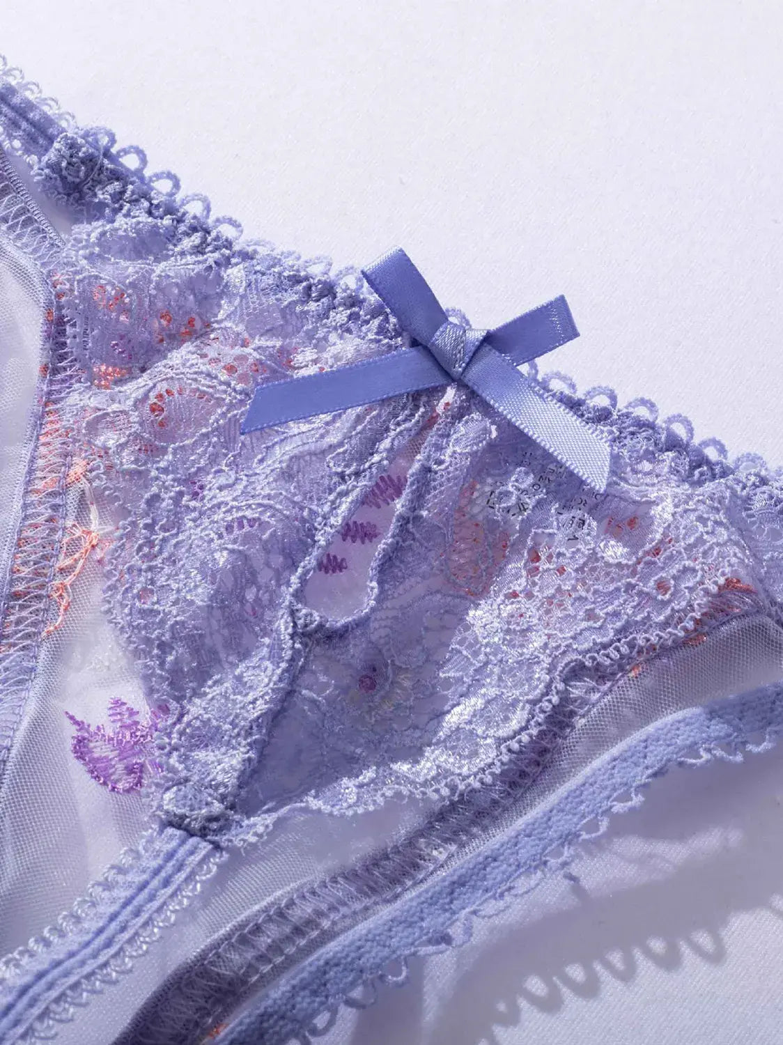 Lavender Bloom lace thong with sheer panels and delicate embroidery.