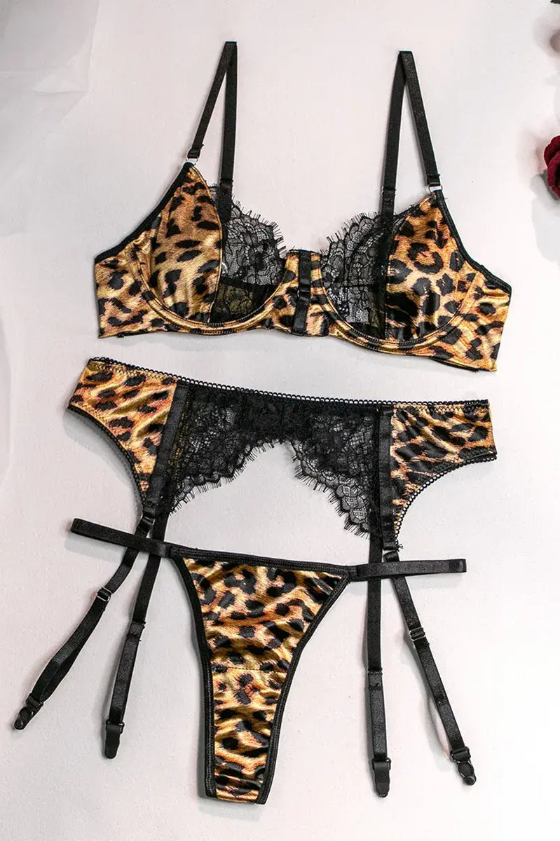 Flat lay of leopard lace bra, thong, and garter belt set