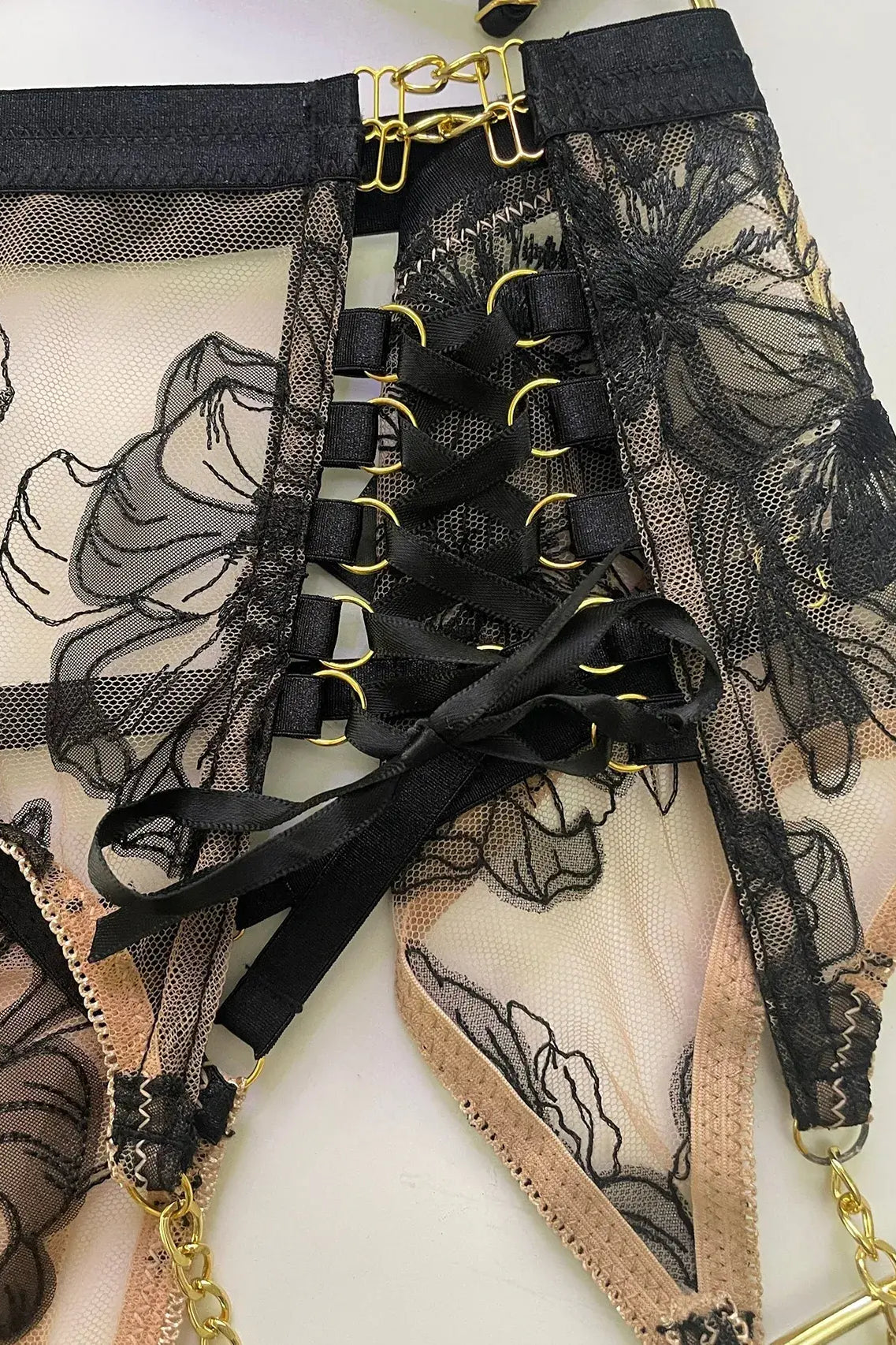 Layflat view of Noir Eclipse garter belt and thigh straps set with gold hardware, complete lingerie accessory for boudoir