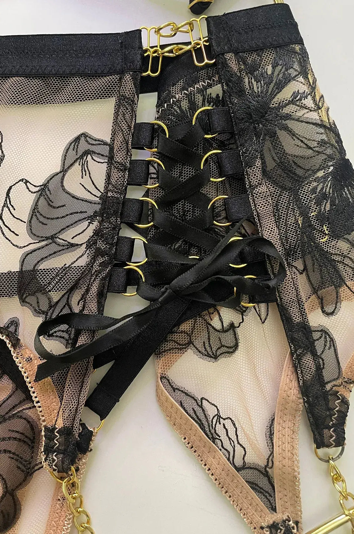 Layflat view of Noir Eclipse garter belt and thigh straps set with gold hardware, complete lingerie accessory for boudoir