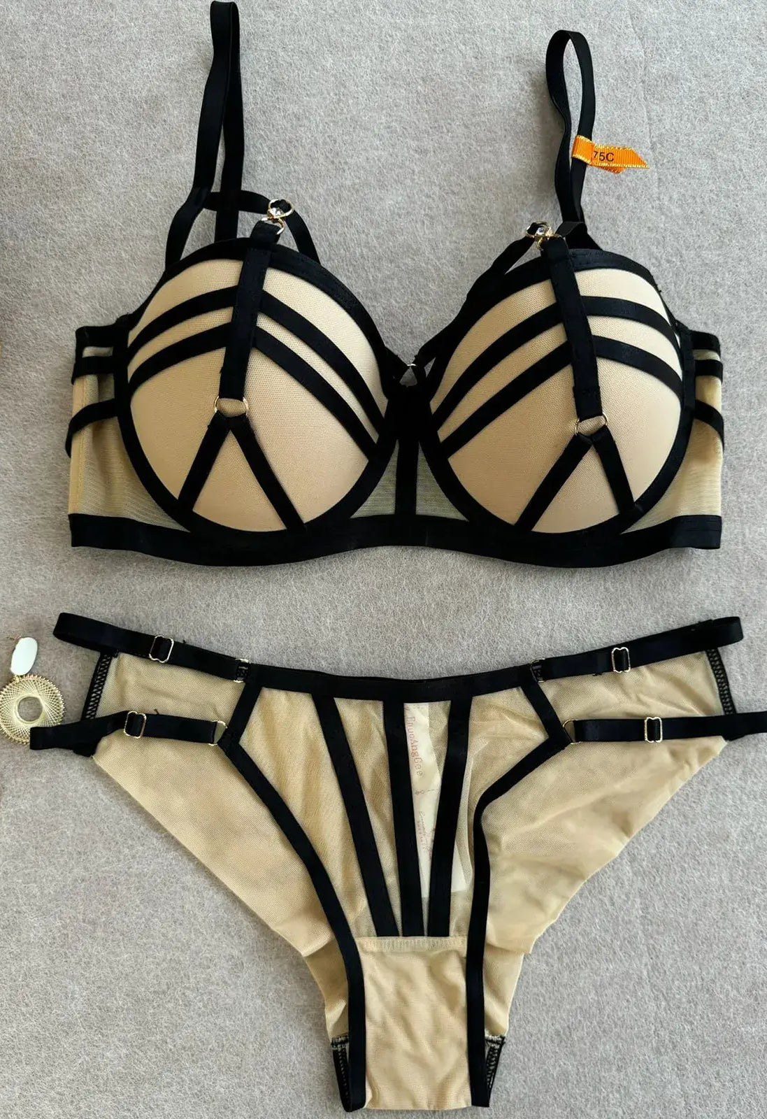 Full view of nude bra and thong set showing structure and balanced design