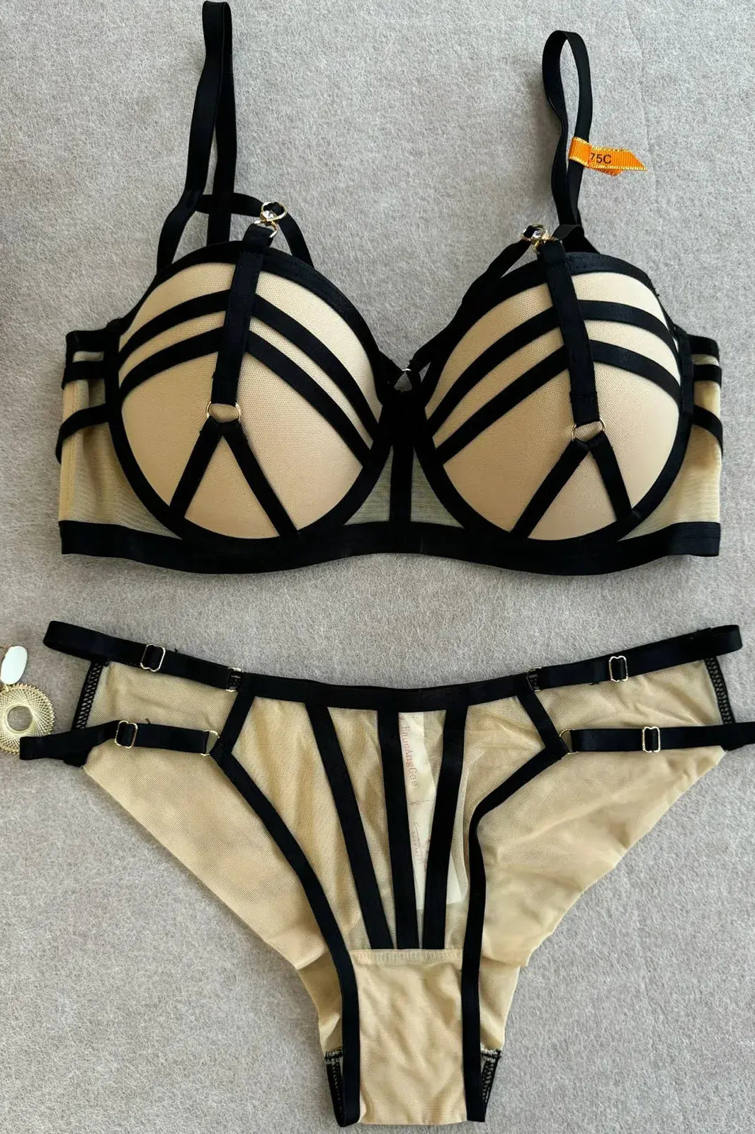 Full view of nude bra and thong set showing structure and balanced design