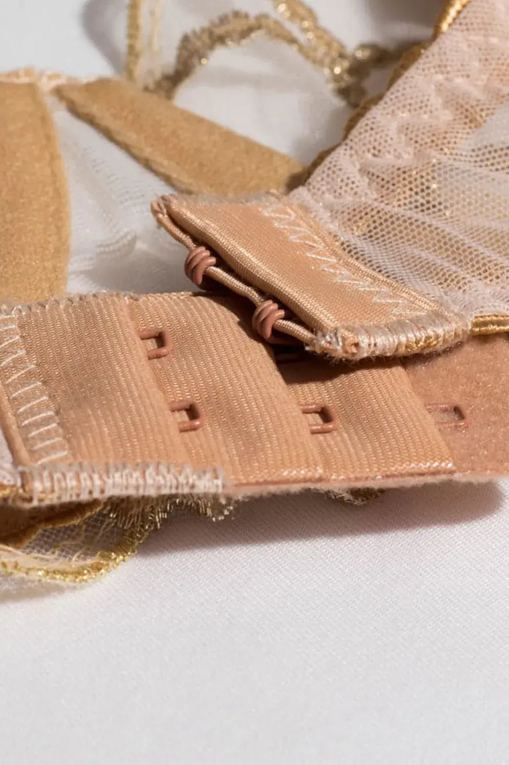 Nude bra underband hook closure design for a secure fit.