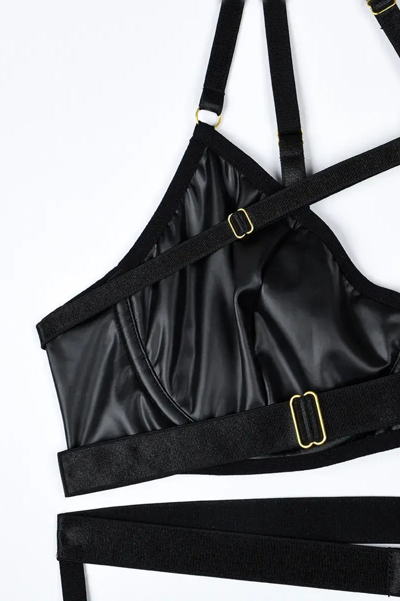 Rich layering of black elastic straps with gold metal link accents, adding bold structure to the Obsidian Edge lingerie set.