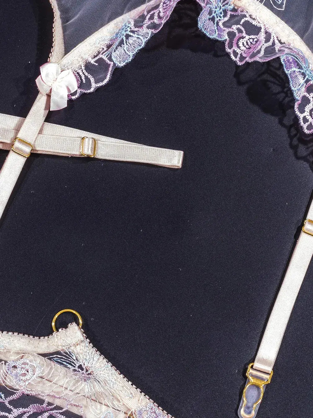 Purple lace lingerie with adjustable elastic straps.