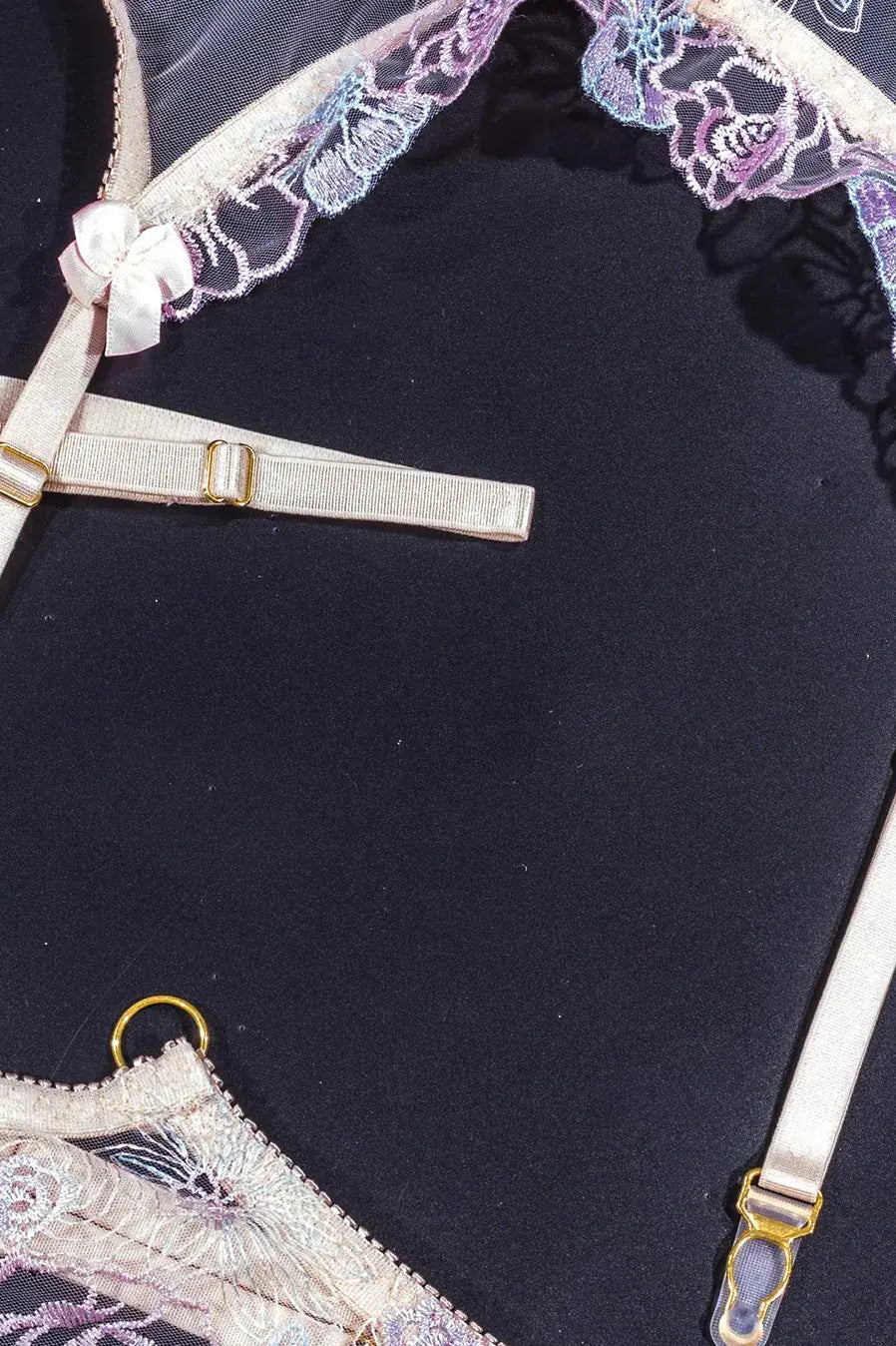 Purple lace lingerie with adjustable elastic straps.