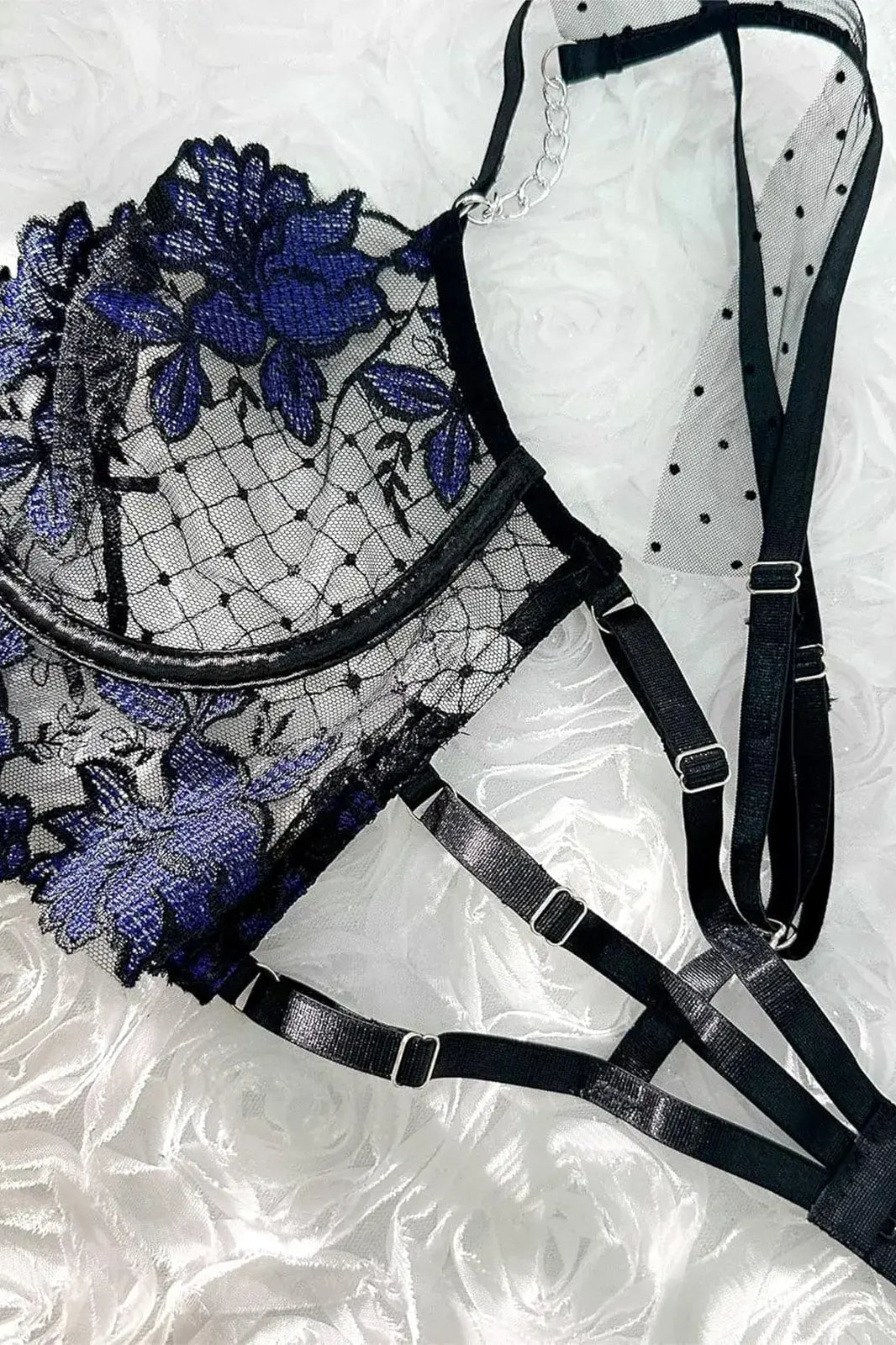 Extreme close-up of sapphire blue sheer lace bra with floral embroidery and underwire support, luxury lingerie craftsmanship