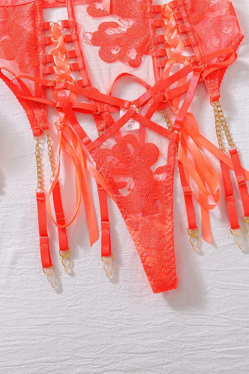 Close-up of orange lace corset belt and garter straps with reinforced stitching