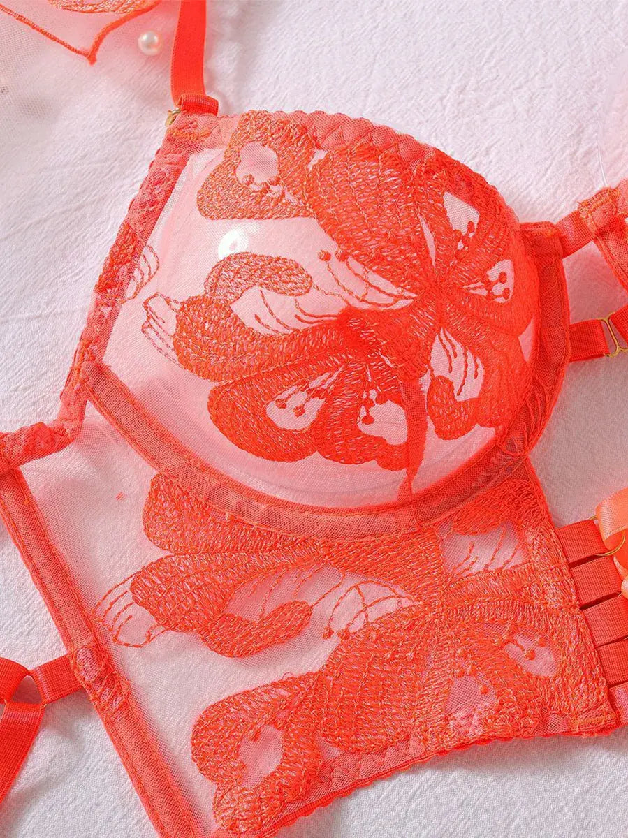 Detailed view of orange sheer lace bra with embroidery and underwire support