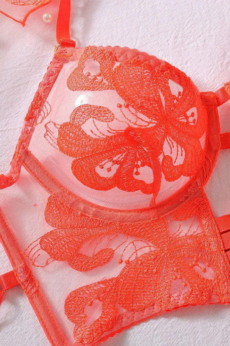 Detailed view of orange sheer lace bra with embroidery and underwire support