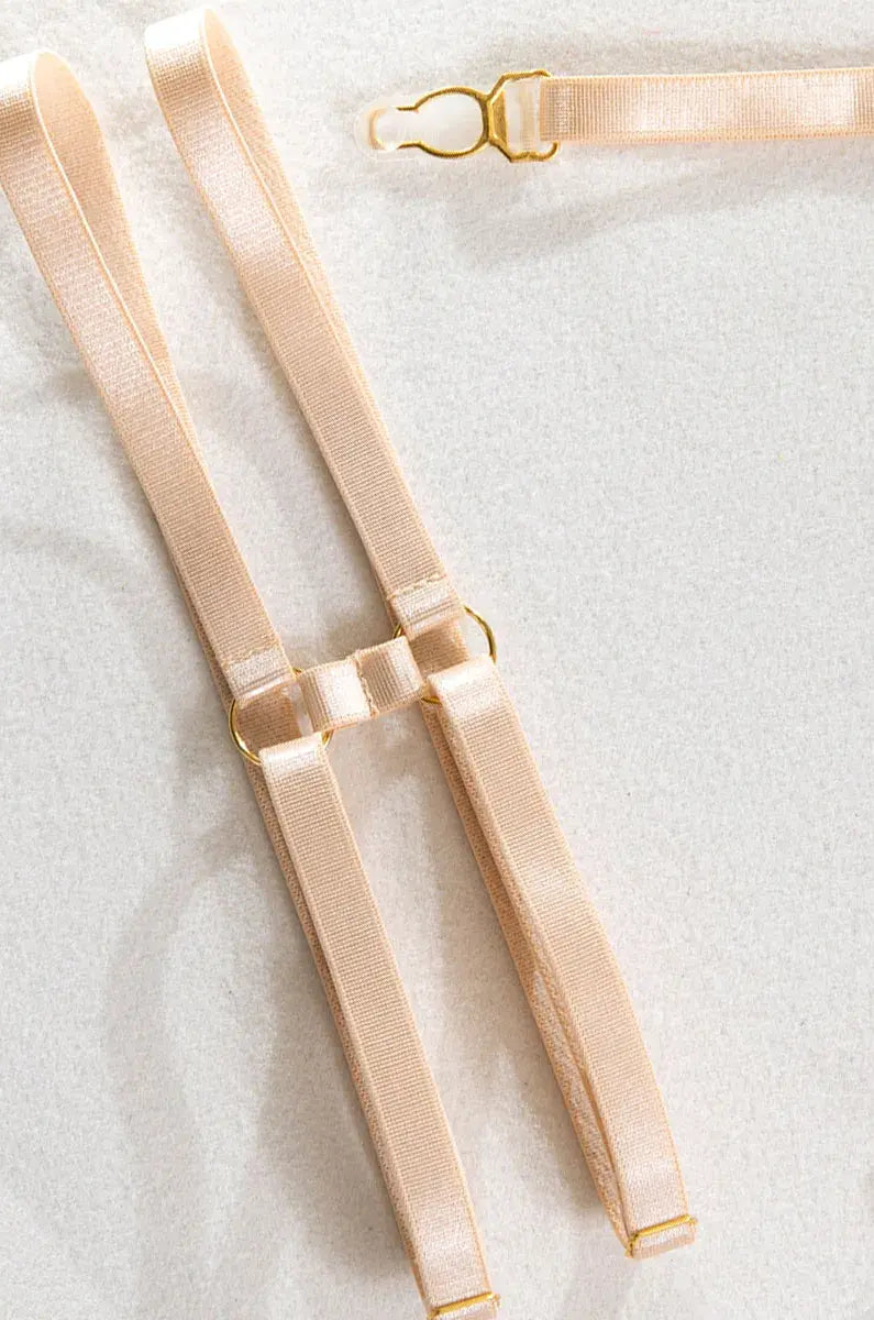 Refined nude leather leg bands with metallic accents and elastic fit from the Velvet Armor lingerie collection.