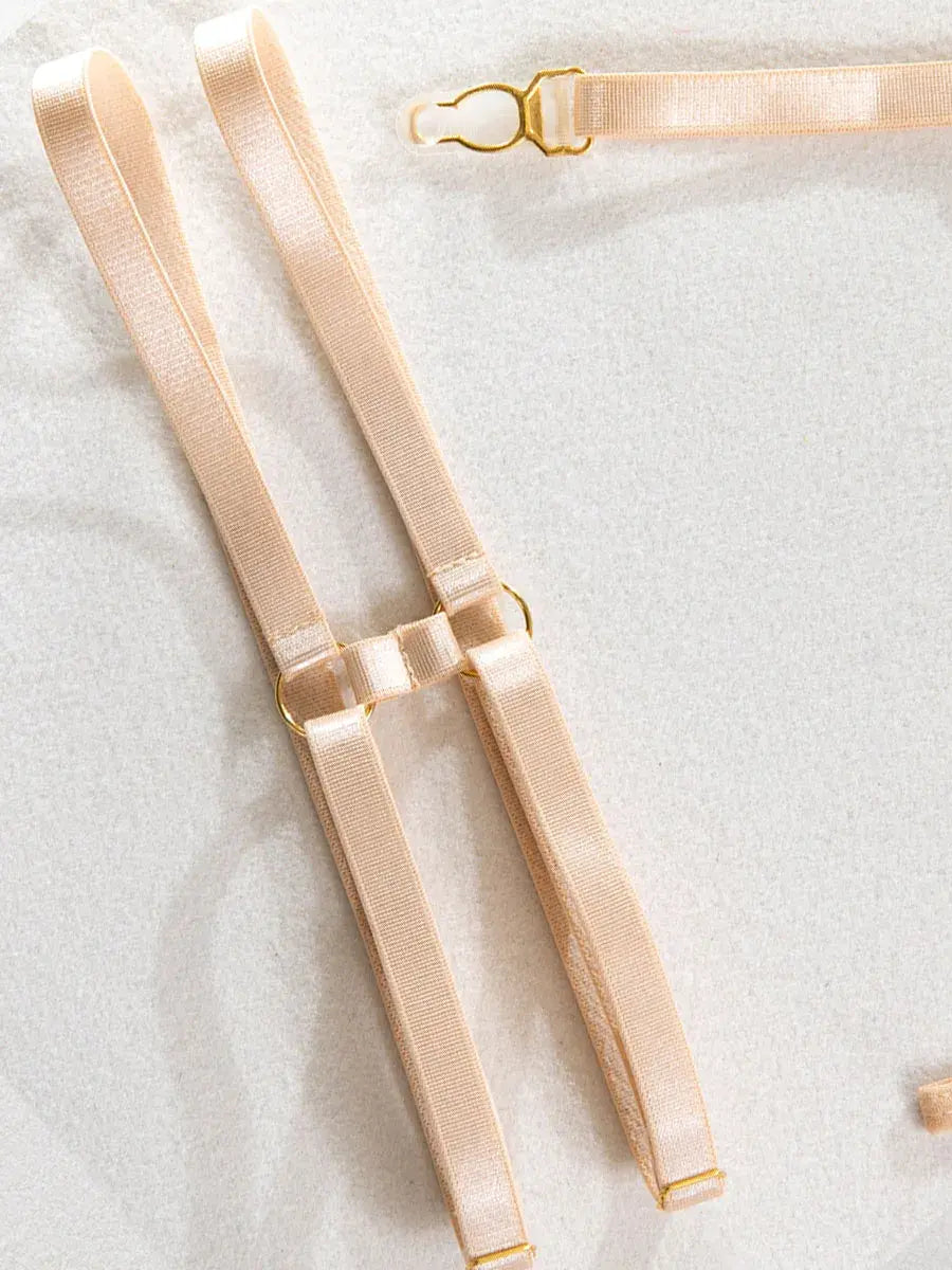 Refined nude leather leg bands with metallic accents and elastic fit from the Velvet Armor lingerie collection.