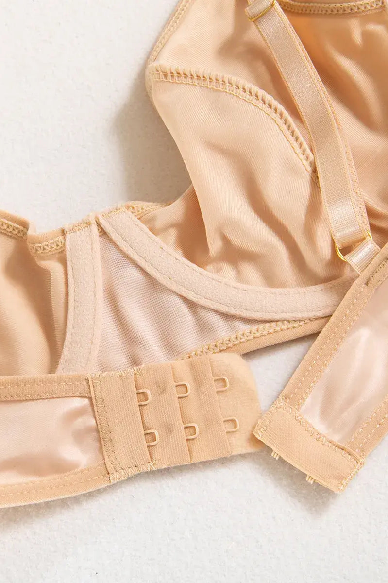 Close-up of precision stitching on the nude PU bodysuit, highlighting minimalist craftsmanship and luxury.