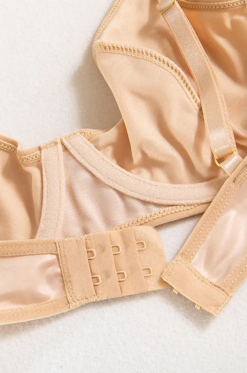 Close-up of precision stitching on the nude PU bodysuit, highlighting minimalist craftsmanship and luxury.
