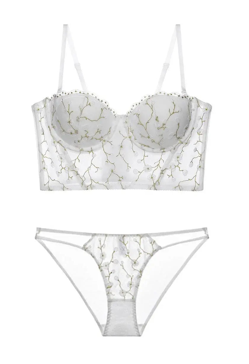 Flat lay back view of ivory corset lingerie set, displaying transparent lace and structured bustier shape.