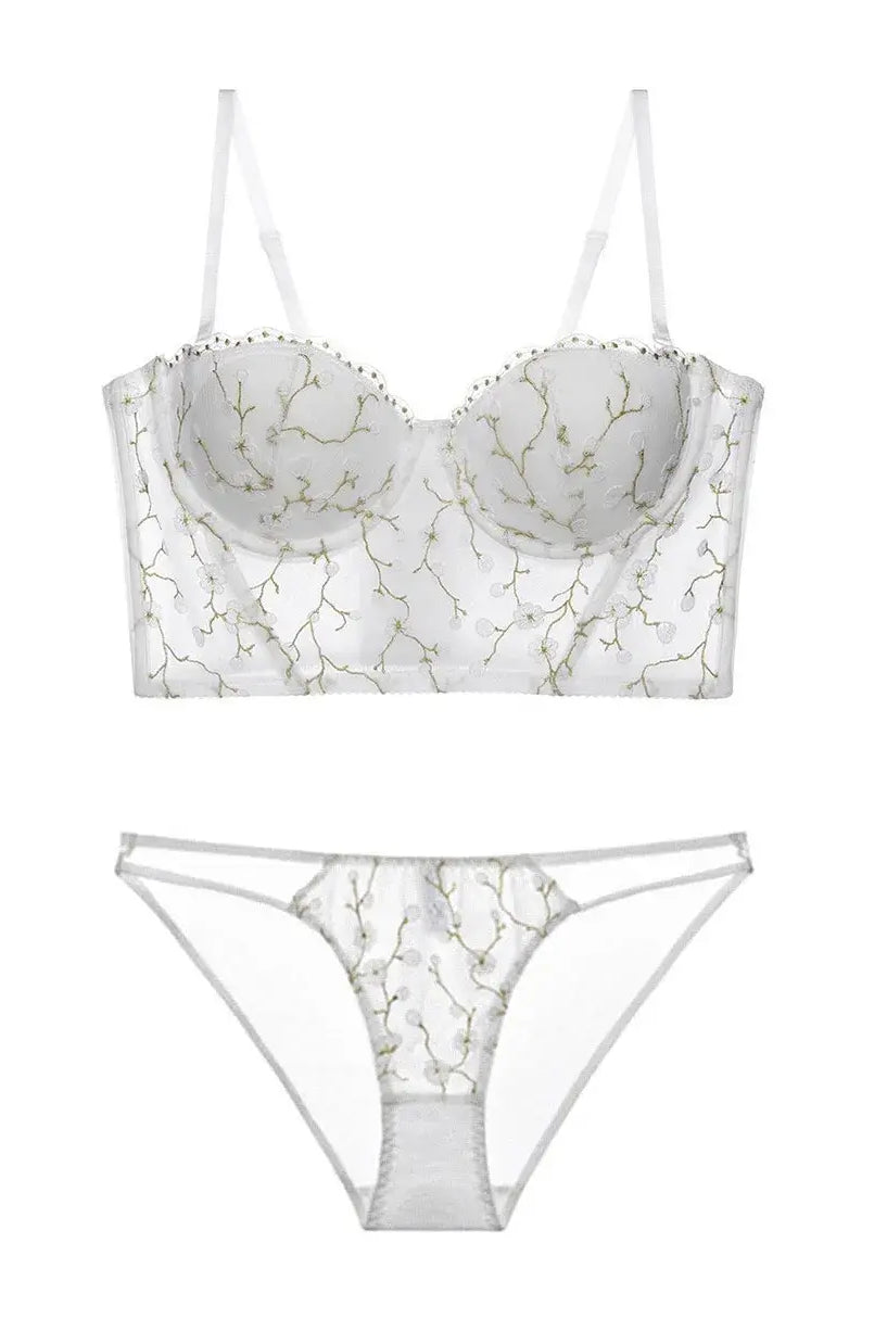 Flat lay back view of ivory corset lingerie set, displaying transparent lace and structured bustier shape.