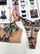 Detailed view of Bare Bloom sheer corset and thong set showing refined embroidery and nude mesh craftsmanship.