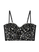 Display of black bustier top lingerie with golden embroidery and sheer lace accents, elegant and bold.