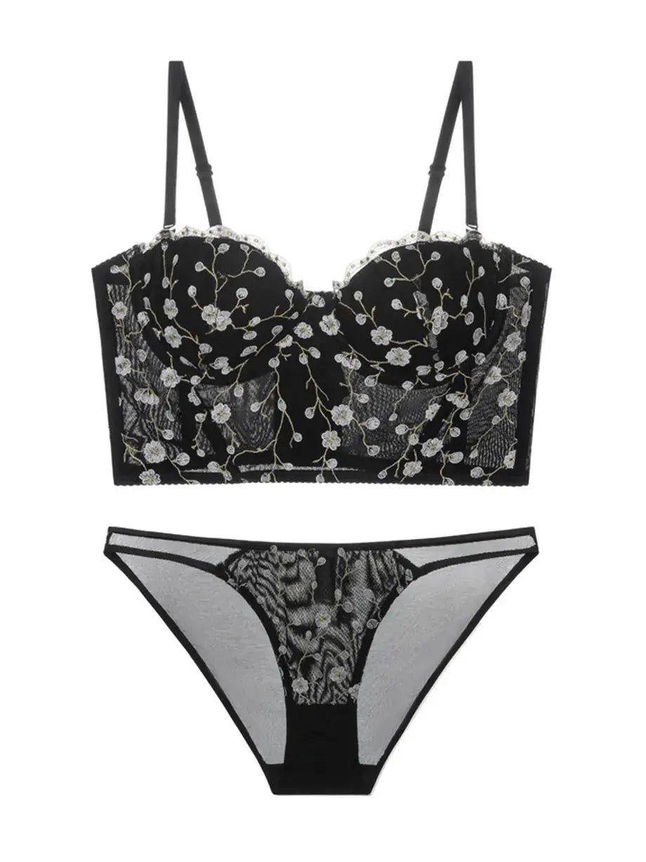 Flat lay back view of black and gold embroidered corset lingerie set, showcasing mesh structure and lace finish.