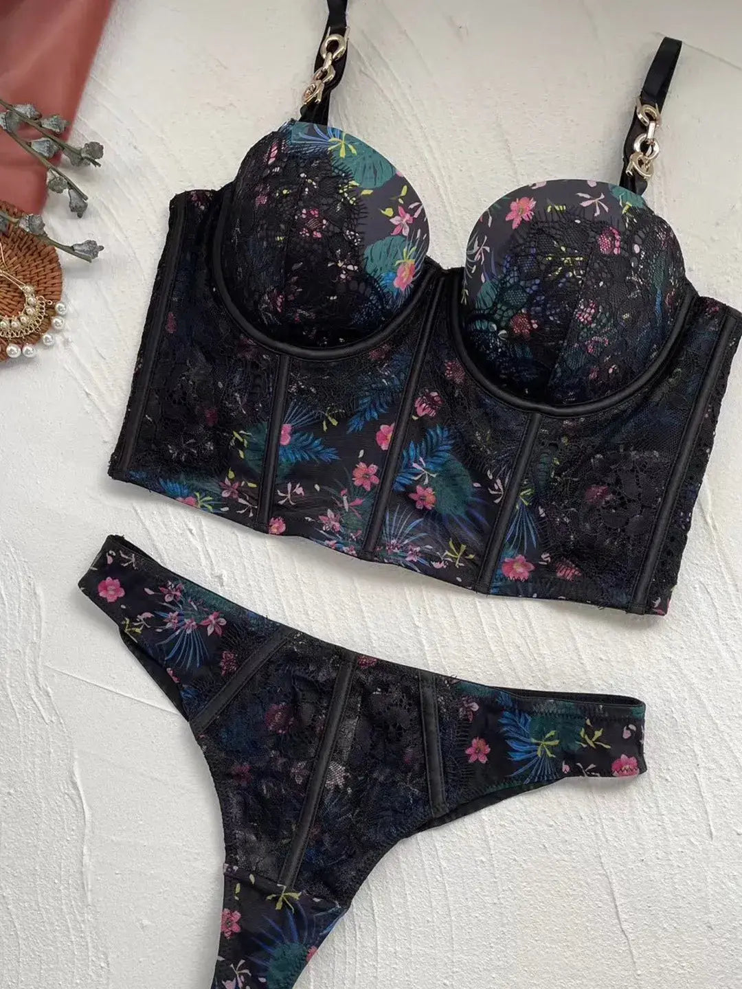 Black lingerie bodysuit for women laid flat to display back lace panel.