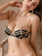 Black strappy bra close-up highlighting bust curve and contour