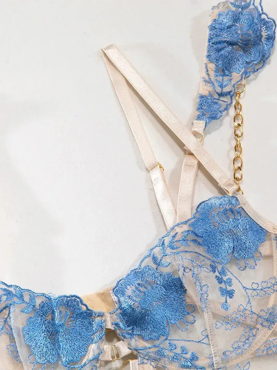 Blue lace bra with embroidered floral patterns and adjustable satin straps, feminine and delicate