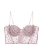 Display of blush pink bustier top lingerie with sheer embroidery and lace accents, soft and romantic style.