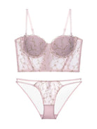 Flat lay back view of blush embroidered corset lingerie set with floral mesh and soft pink tones.
