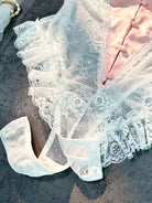 Close-up of open crotch design on Blush Pink Satin Lace Teddy showcasing functional detail.