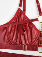 Close-up of burgundy PU leather highlighting precise seams and detailed craftsmanship from the Crimson Obsession set.